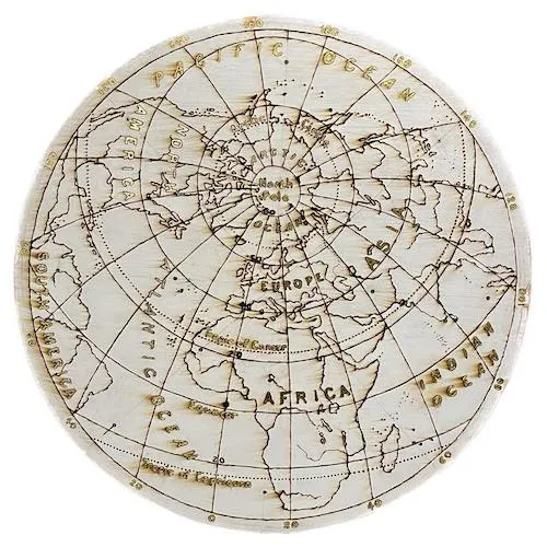A photo of a planisphere in pyrography and golf leaf.